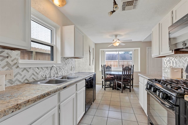 kitchen featuring decorative backsplash, sink, white cabinetry, and black appliances