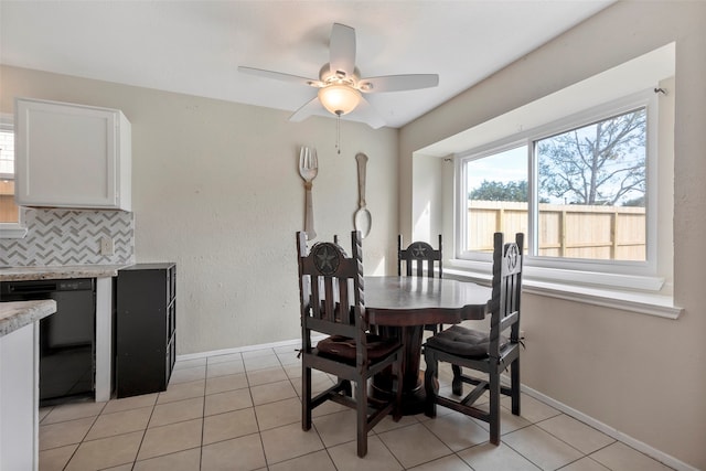 tiled dining space featuring ceiling fan