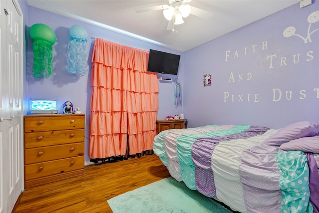 bedroom featuring ceiling fan, hardwood / wood-style flooring, and a closet