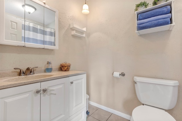 bathroom with vanity, toilet, and tile patterned floors