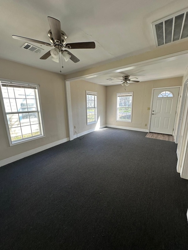 carpeted spare room with ceiling fan