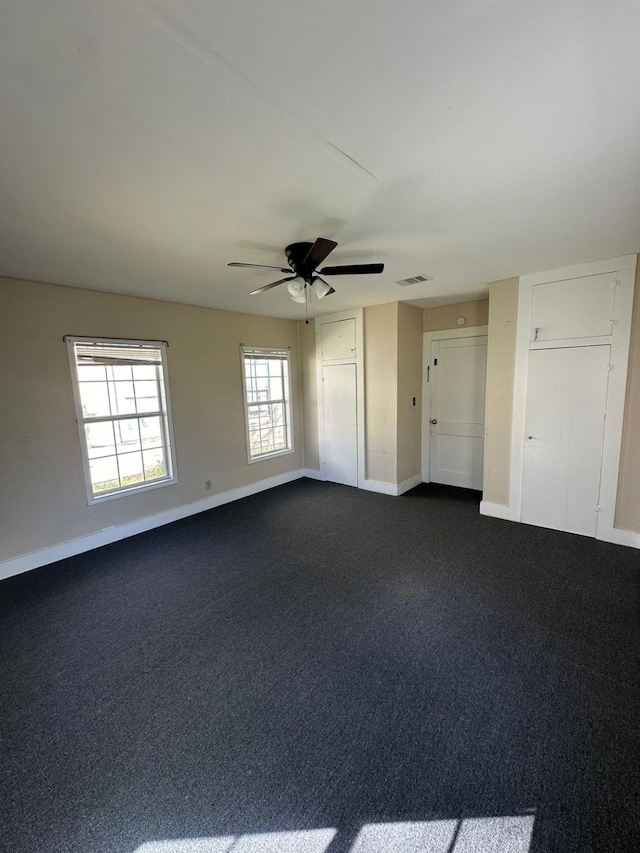 carpeted empty room featuring ceiling fan