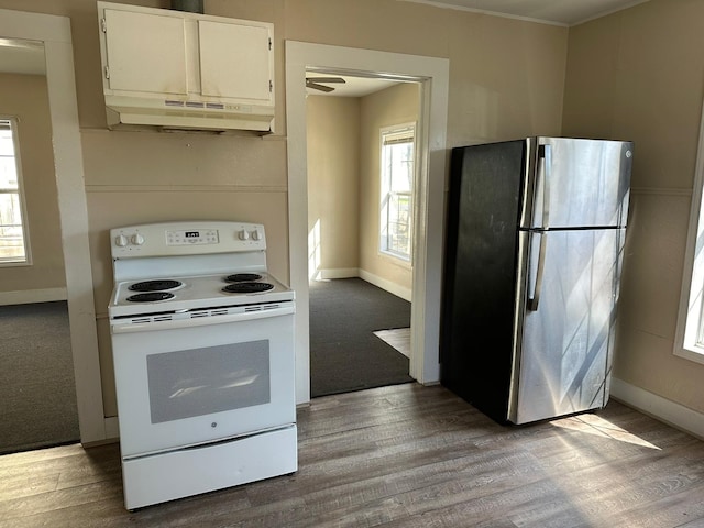 kitchen featuring light wood-type flooring, white cabinetry, white range with electric cooktop, and stainless steel refrigerator