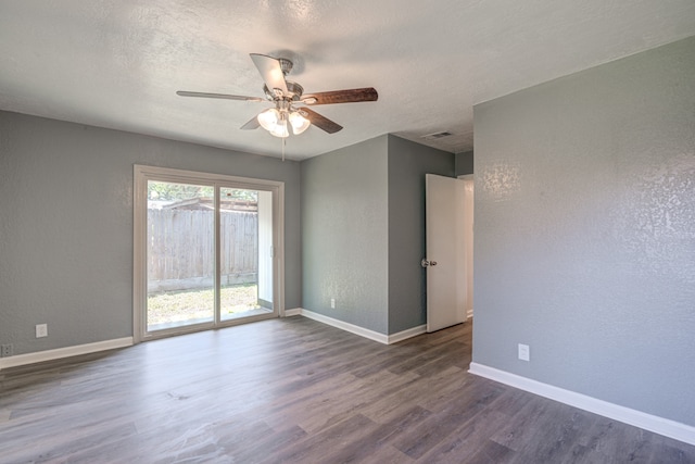 spare room featuring ceiling fan, a textured ceiling, and dark wood-type flooring