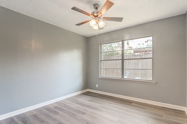 spare room featuring hardwood / wood-style floors and ceiling fan