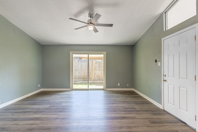 spare room with a textured ceiling, ceiling fan, and dark hardwood / wood-style flooring