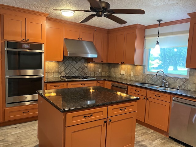 kitchen featuring a textured ceiling, sink, light hardwood / wood-style flooring, stainless steel appliances, and ceiling fan