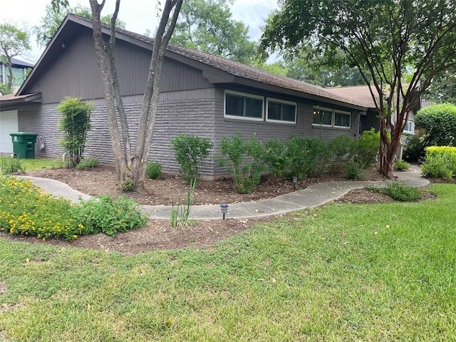 9614 Greenwillow St, Houston, TX 77096 - view of home's exterior with brick siding, a yard, and a garage