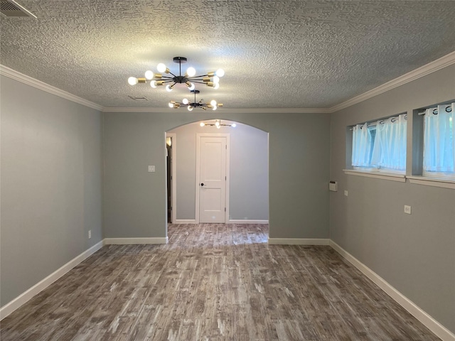 9614 Greenwillow St, Houston, TX 77096 - empty room with arched walkways, wood finished floors, ornamental molding, a textured ceiling, and a chandelier