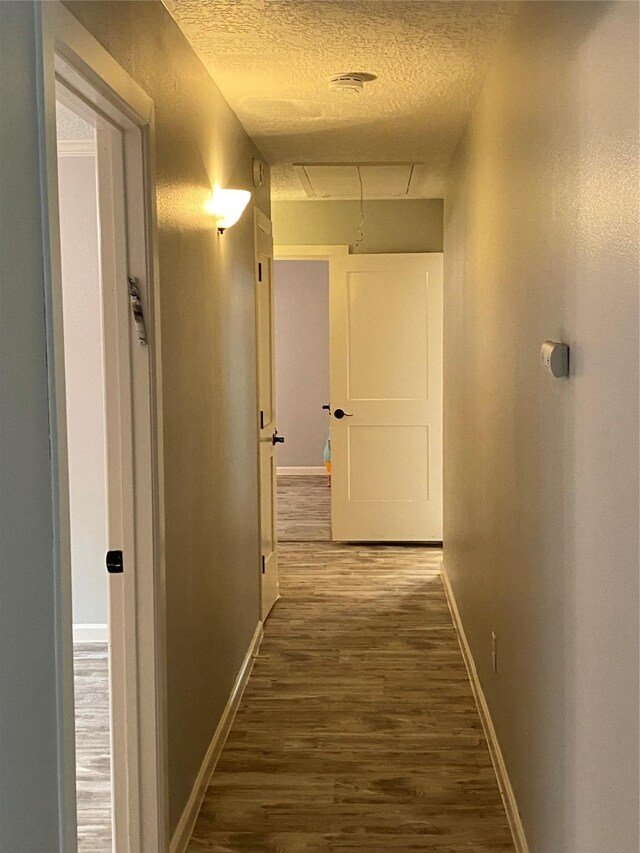 9614 Greenwillow St, Houston, TX 77096 - corridor with a textured ceiling, wood finished floors, baseboards, and attic access