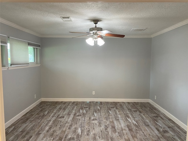 spare room featuring ornamental molding, a textured ceiling, and dark hardwood / wood-style flooring