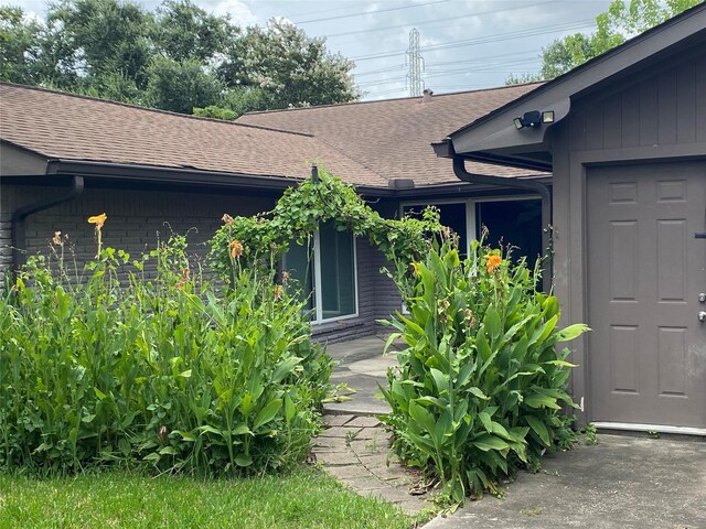 9614 Greenwillow St, Houston, TX 77096 - view of exterior entry featuring roof with shingles
