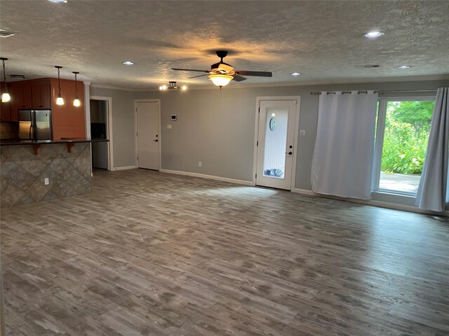 9614 Greenwillow St, Houston, TX 77096 - unfurnished living room featuring a textured ceiling, wood finished floors, ornamental molding, baseboards, and a ceiling fan