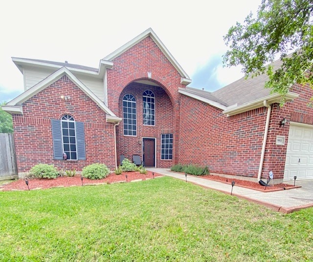 view of front property with a garage and a front lawn