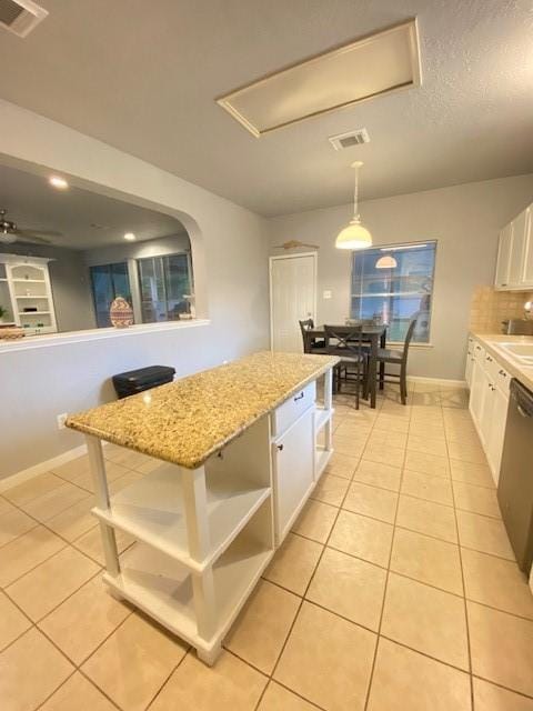19603 Huckleberry Branch Ct, Spring, TX 77388 - kitchen featuring open shelves, white cabinets, light tile patterned floors, a center island, and stainless steel dishwasher