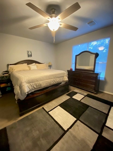 bedroom featuring light hardwood / wood-style floors and ceiling fan