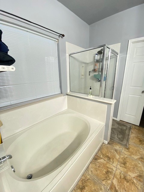 bathroom featuring independent shower and bath and tile patterned flooring