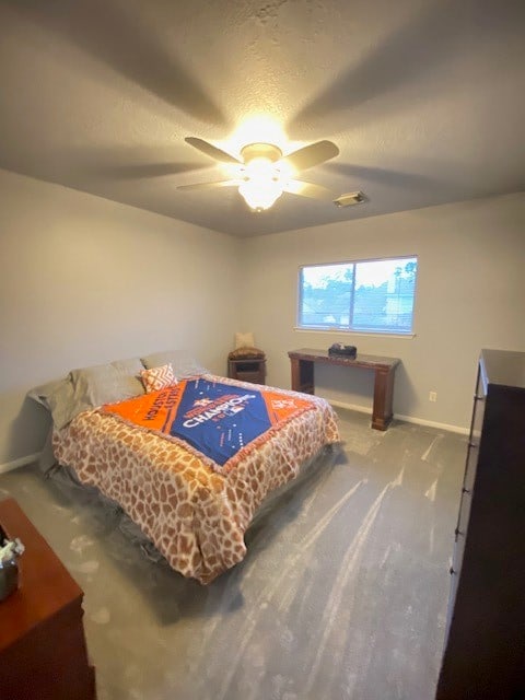 bedroom featuring carpet, ceiling fan, and a textured ceiling