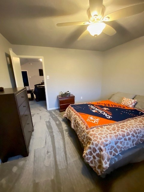 bedroom with ceiling fan and light carpet