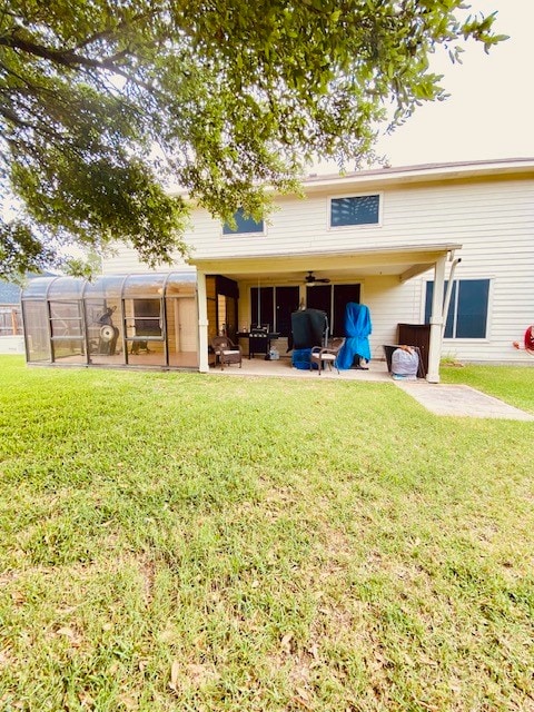 back of property featuring a lawn and a patio