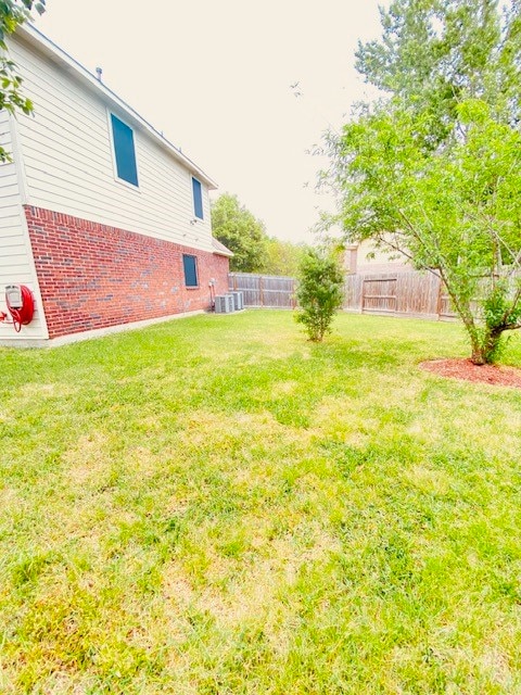 view of yard with central AC