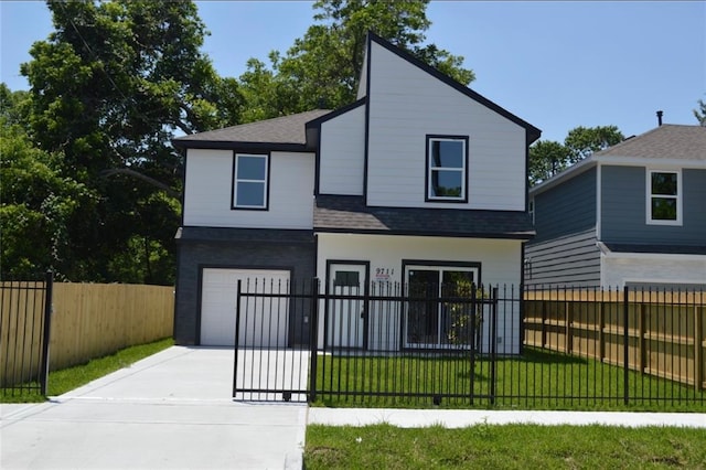 view of front of property featuring a garage and a front yard