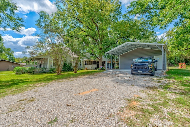 view of front of property with a front lawn, covered porch, and a carport