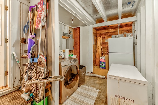 miscellaneous room with wooden walls and washer / dryer