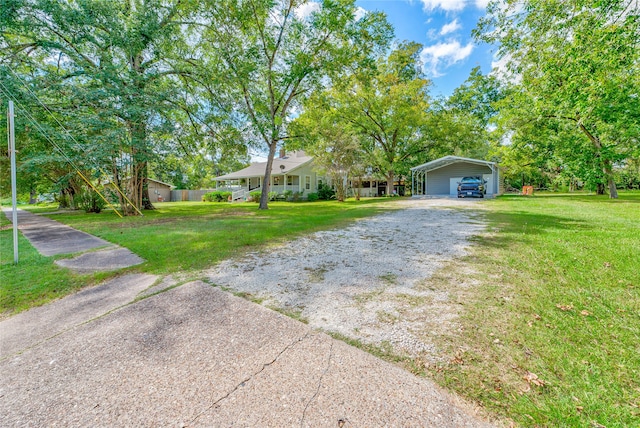 view of yard with a carport and a garage