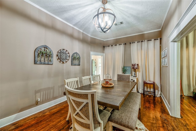 dining area with ornamental molding, a textured ceiling, a chandelier, and dark hardwood / wood-style flooring