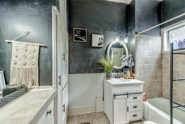 bathroom with tiled shower / bath, vanity, and tile patterned floors