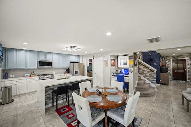 dining area with light tile patterned flooring and sink