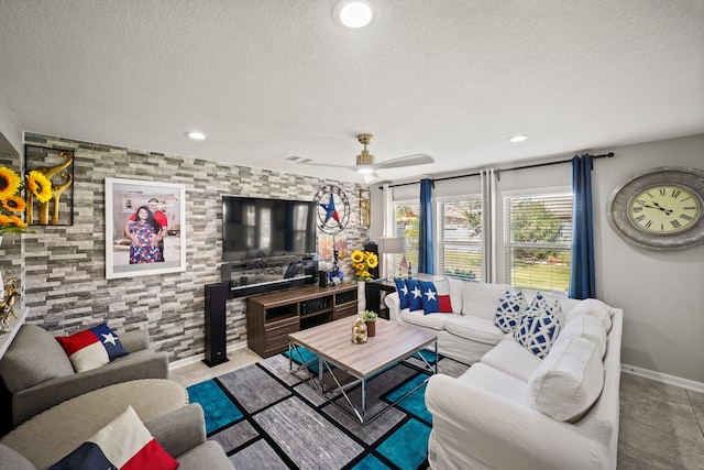 living room with a textured ceiling and ceiling fan