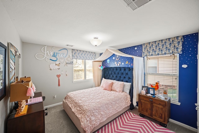 carpeted bedroom featuring a textured ceiling