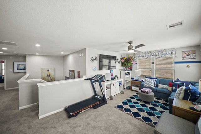 exercise room featuring ceiling fan and carpet floors