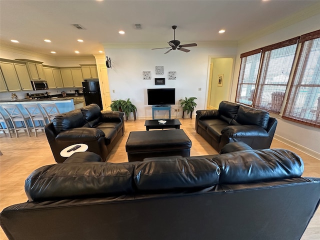 living room featuring crown molding and ceiling fan