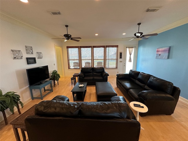 living room featuring light hardwood / wood-style floors, ornamental molding, and ceiling fan