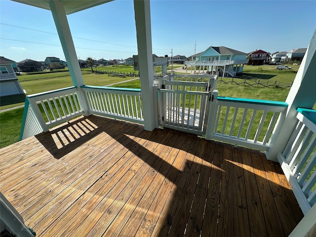 wooden deck featuring a lawn