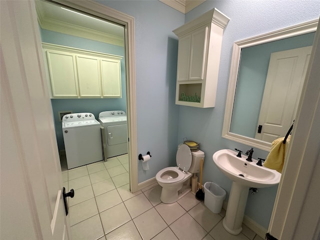 bathroom with crown molding, toilet, separate washer and dryer, and tile patterned floors