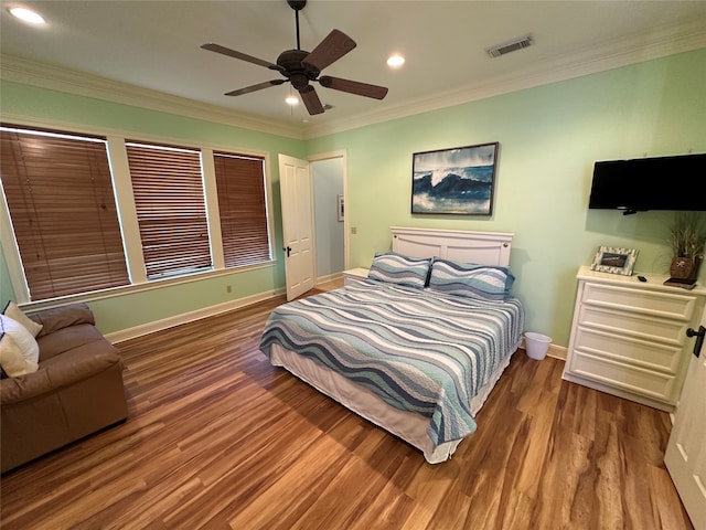 bedroom featuring crown molding, hardwood / wood-style floors, and ceiling fan