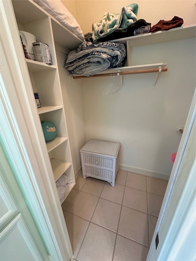 walk in closet with light tile patterned flooring