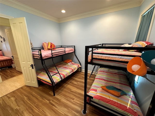 bedroom featuring ornamental molding and wood-type flooring