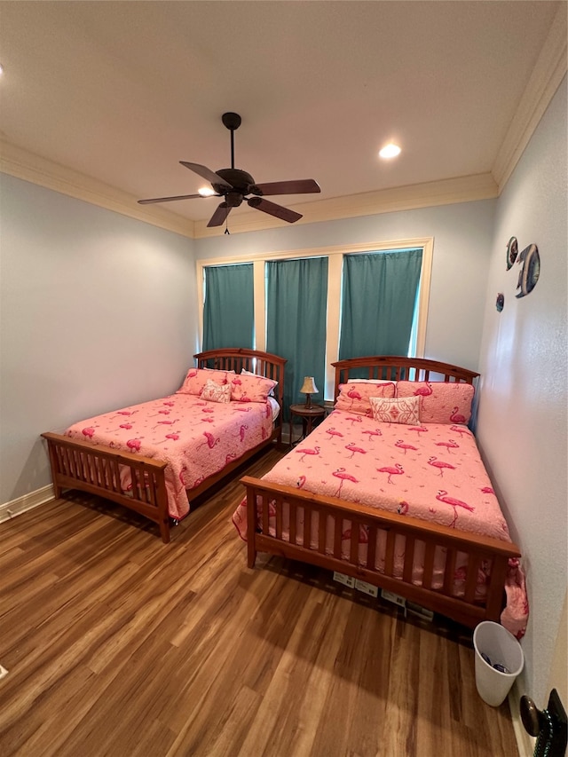 bedroom featuring crown molding, ceiling fan, and hardwood / wood-style floors