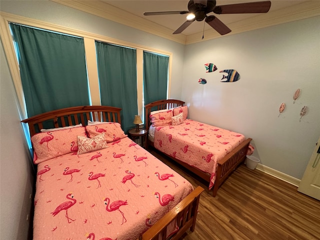 bedroom with ornamental molding, ceiling fan, and dark hardwood / wood-style flooring