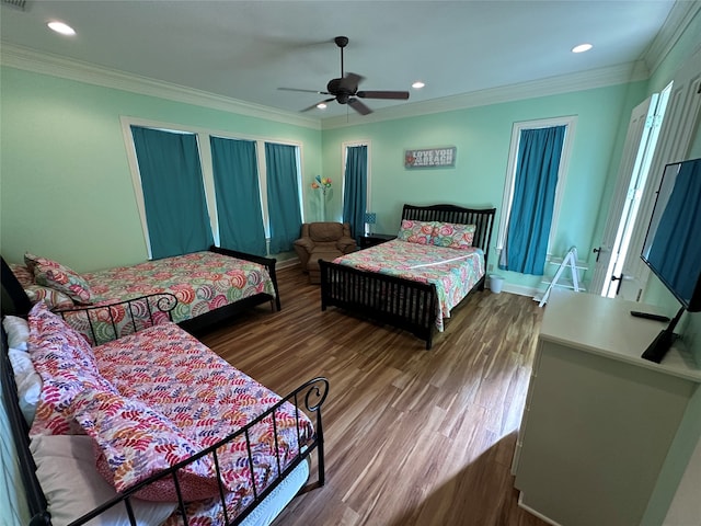 bedroom with ornamental molding, hardwood / wood-style flooring, and ceiling fan