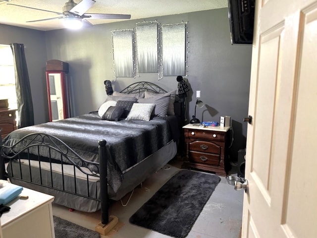 bedroom with ceiling fan and concrete floors