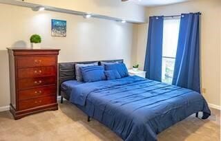 bedroom with light colored carpet