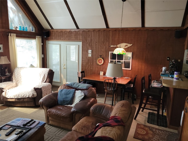 living room featuring wooden walls and lofted ceiling with beams