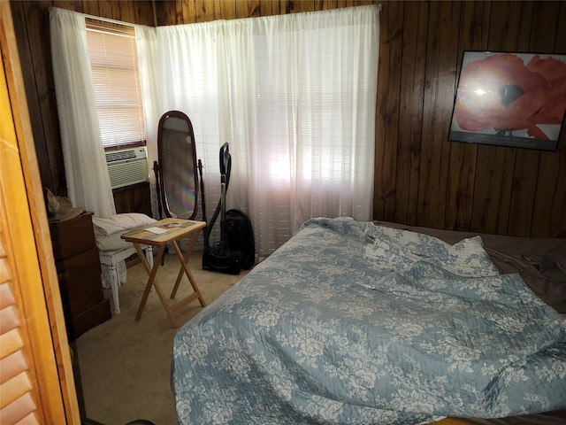 bedroom featuring cooling unit, wooden walls, and carpet flooring