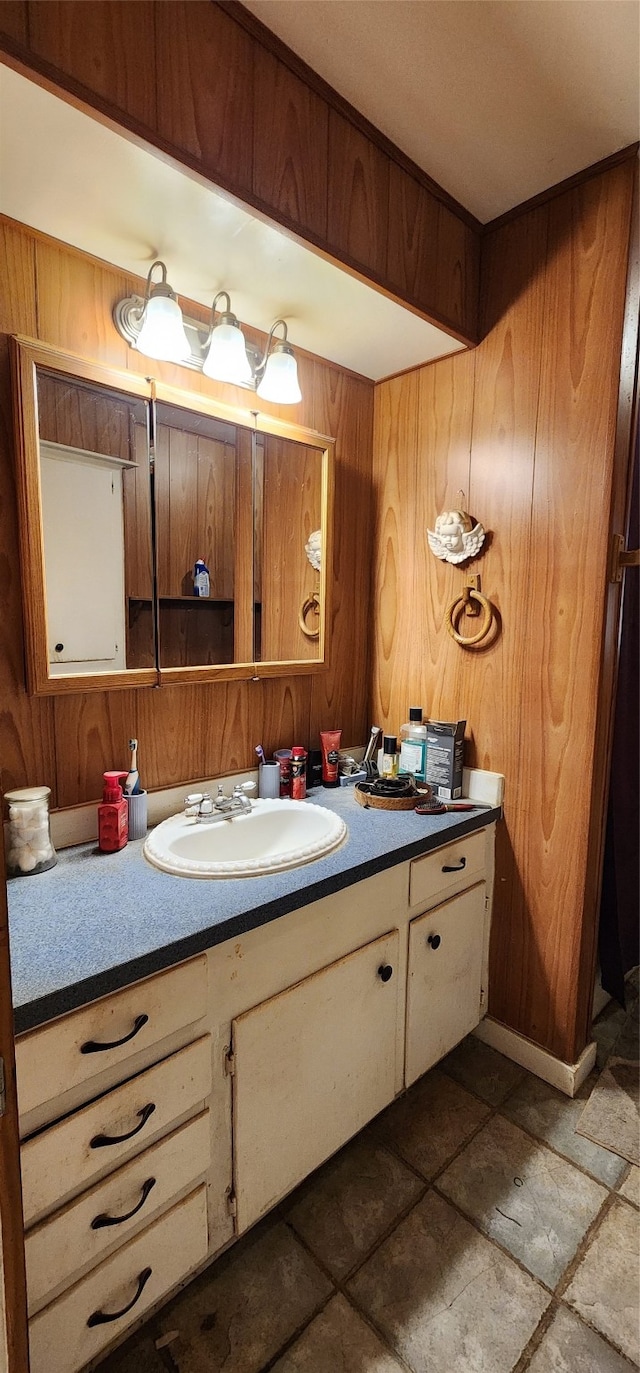 bathroom featuring wooden walls and vanity